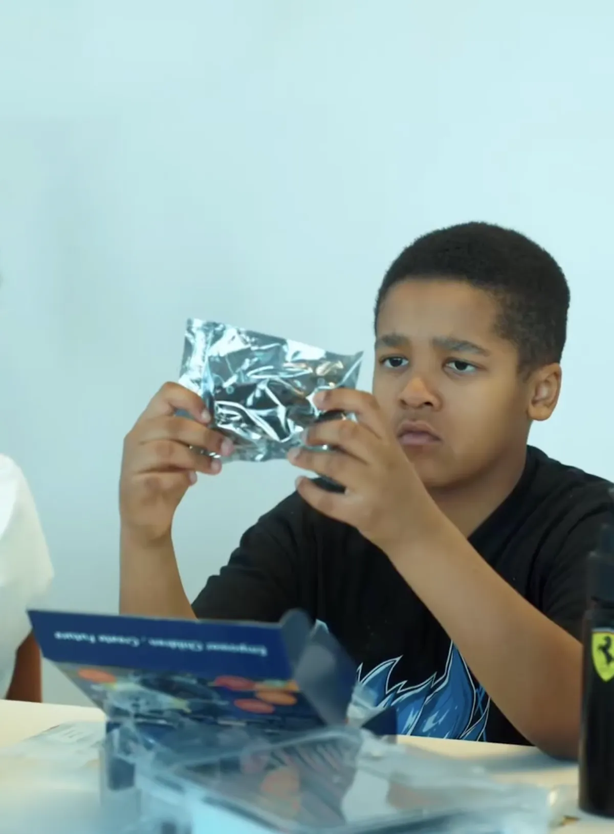 A student unpacking robotics components at House of Wisdom, Sharjah