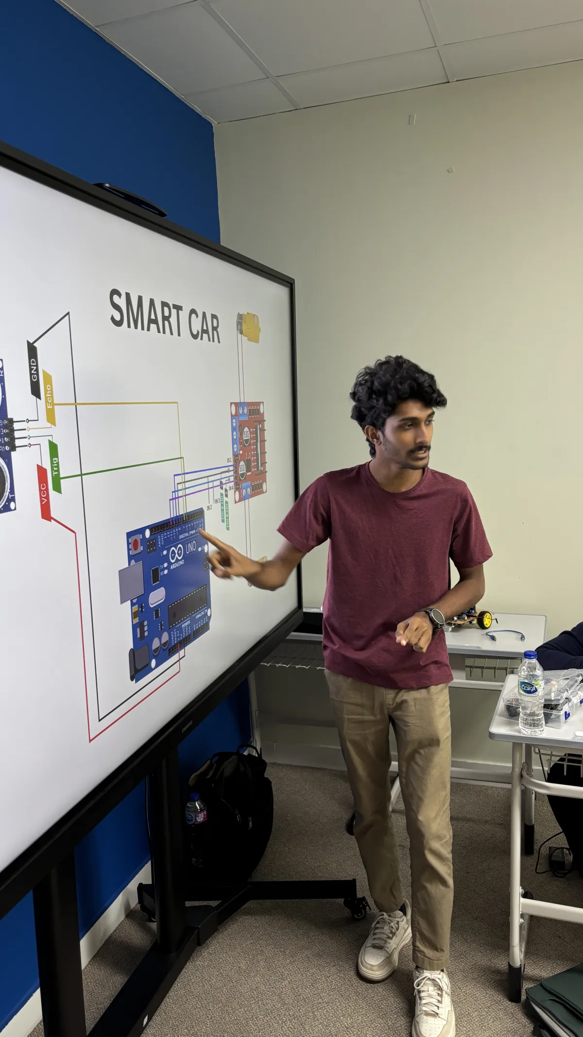 A Steyp trainer explaining a smart car circuit during the LearnGate summer program in Dubai